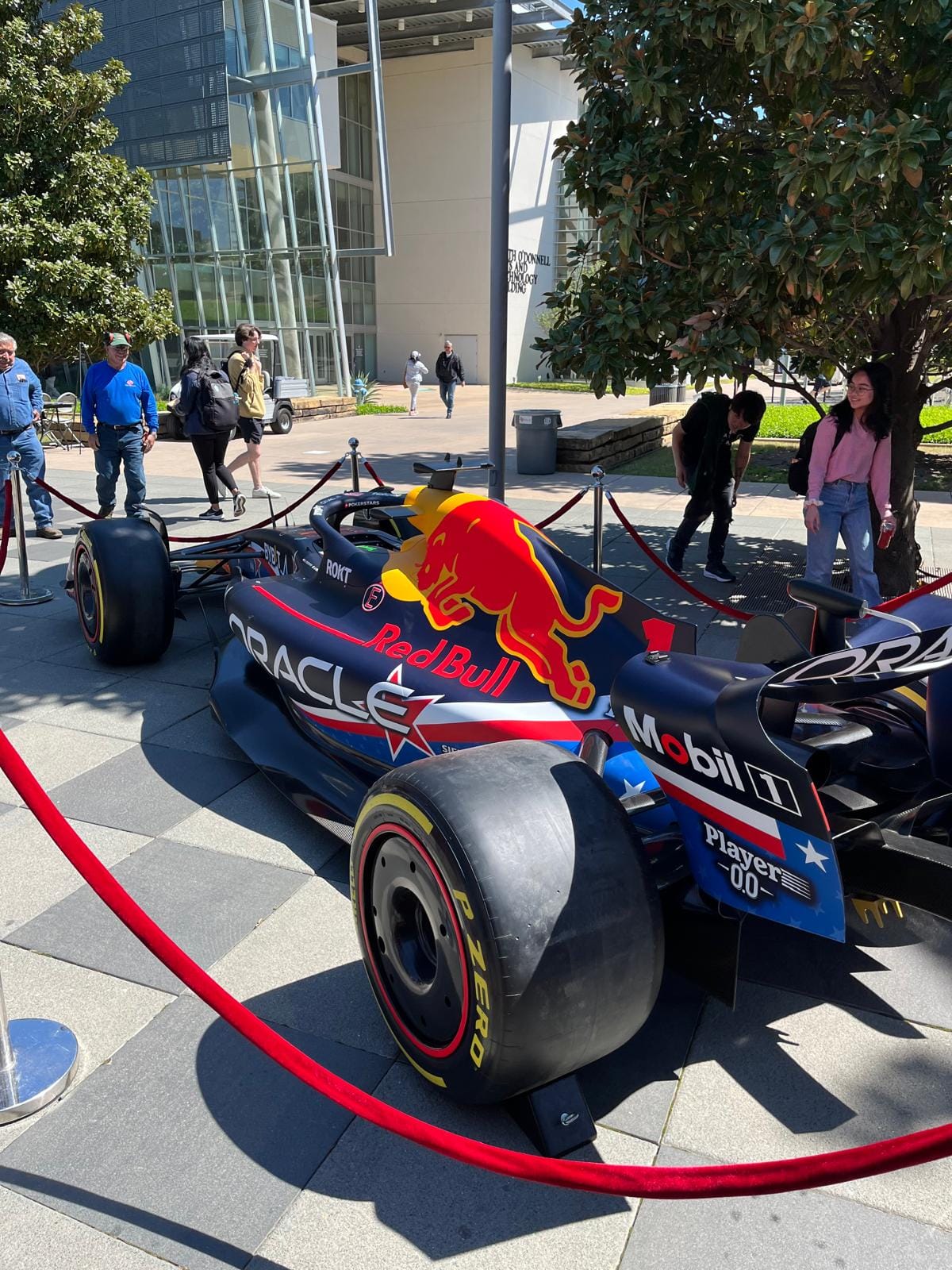 An Oracle Red Bull F1 show car parked on campus.