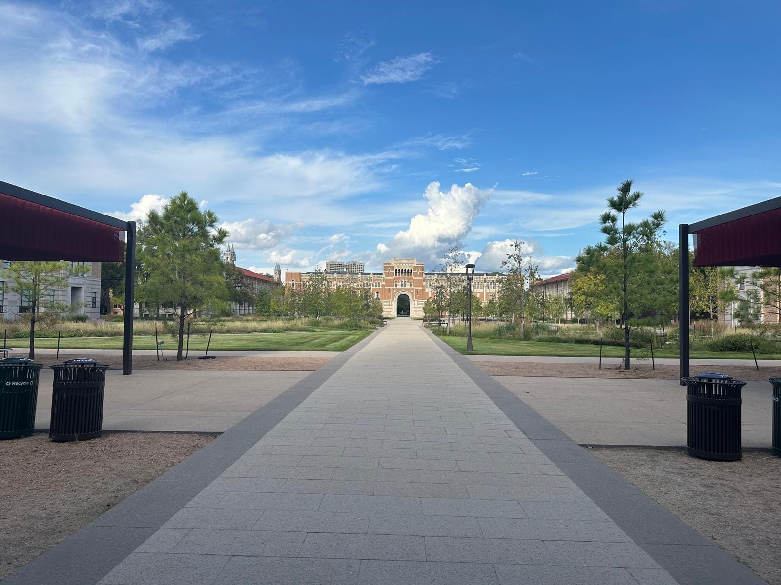 The SMU boulevard toward Dallas Hall under a blue sky.
